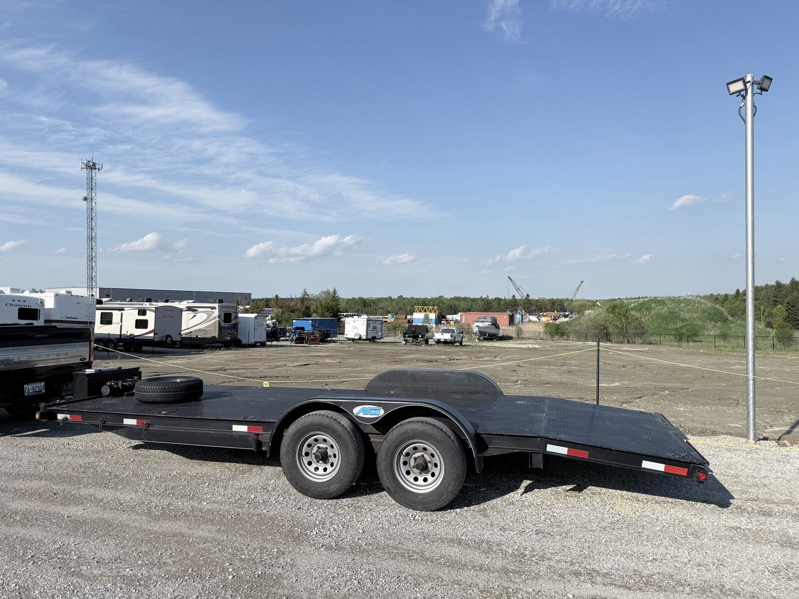 Heavy-duty tandem-axle car hauler trailer with beavertail for rent in York Region